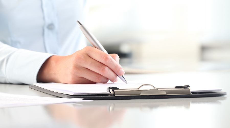 person filling out employee information form