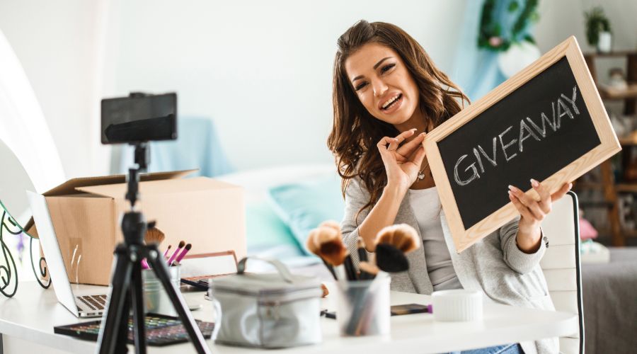 woman holding a sign that says giveaway