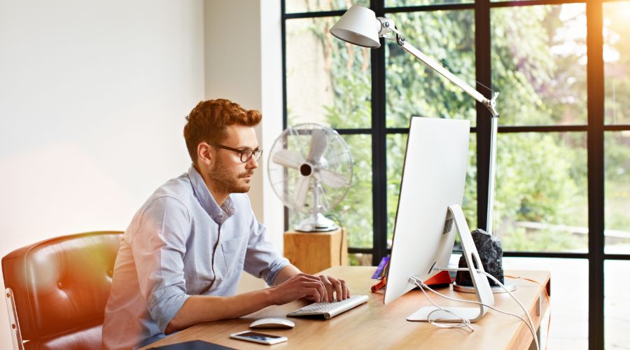 Remote employee working on a computer in his home office