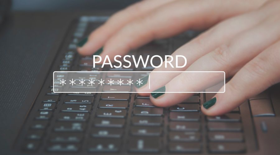 Person typing password on keyboard into password box