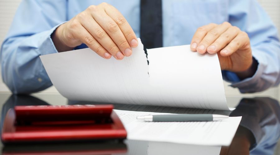 businessman tearing up a resume